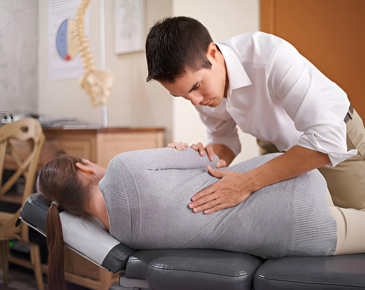 Orlando Chiropractors and staff at Lake Mary Spine & Rehabilitation Center Shot of a chiropractor adjusting a young woman's spine